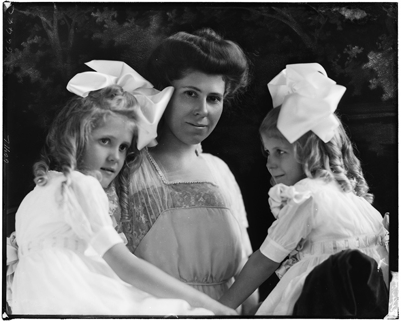 <h4>Photographed by J.C. Strauss</h4>
<p>Mother and her two daughters taken in August of 1911. This image is part of a collection of glass plate negatives that were purchased by SLPL in 2011 from a collector of Strauss materials. The glass plates had been found at 11203 Francis Place in St. Louis, which had once been a location for Edwyn Studios the successor to Strauss Studios.</p>
